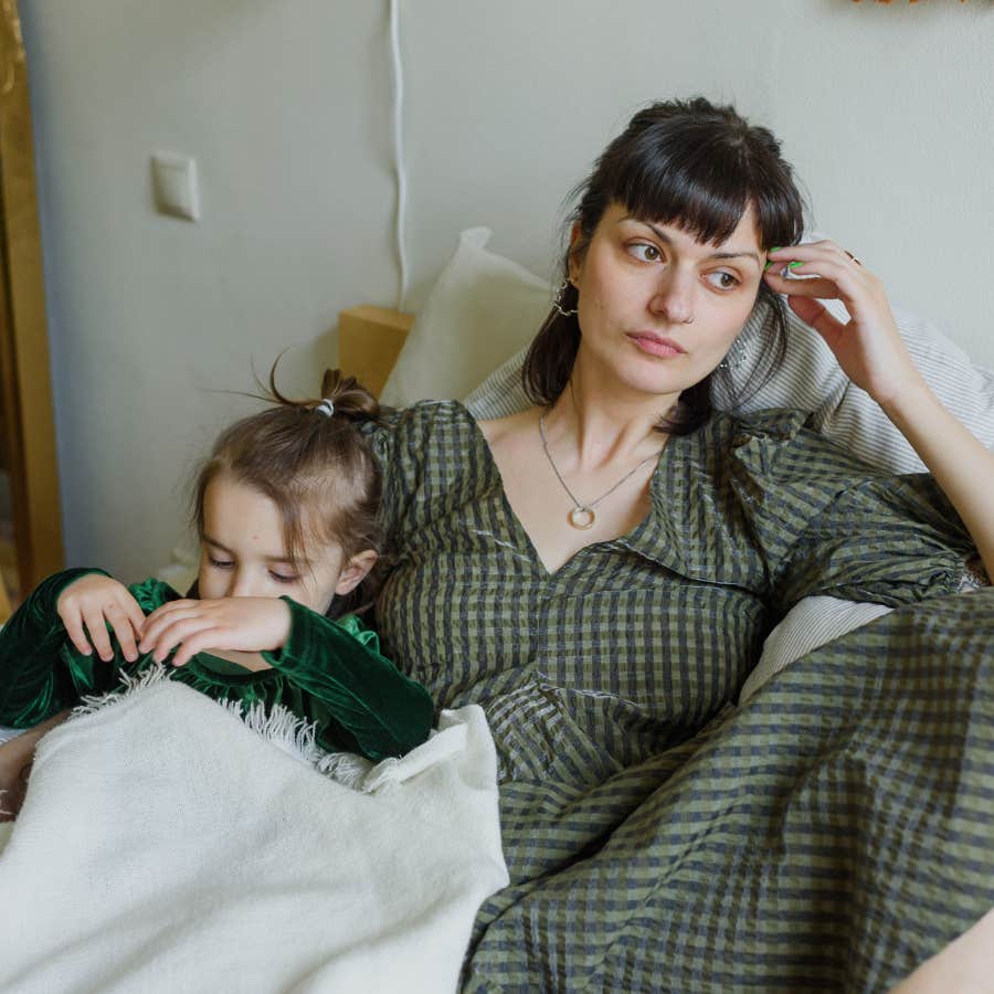 tired mom sitting with young child