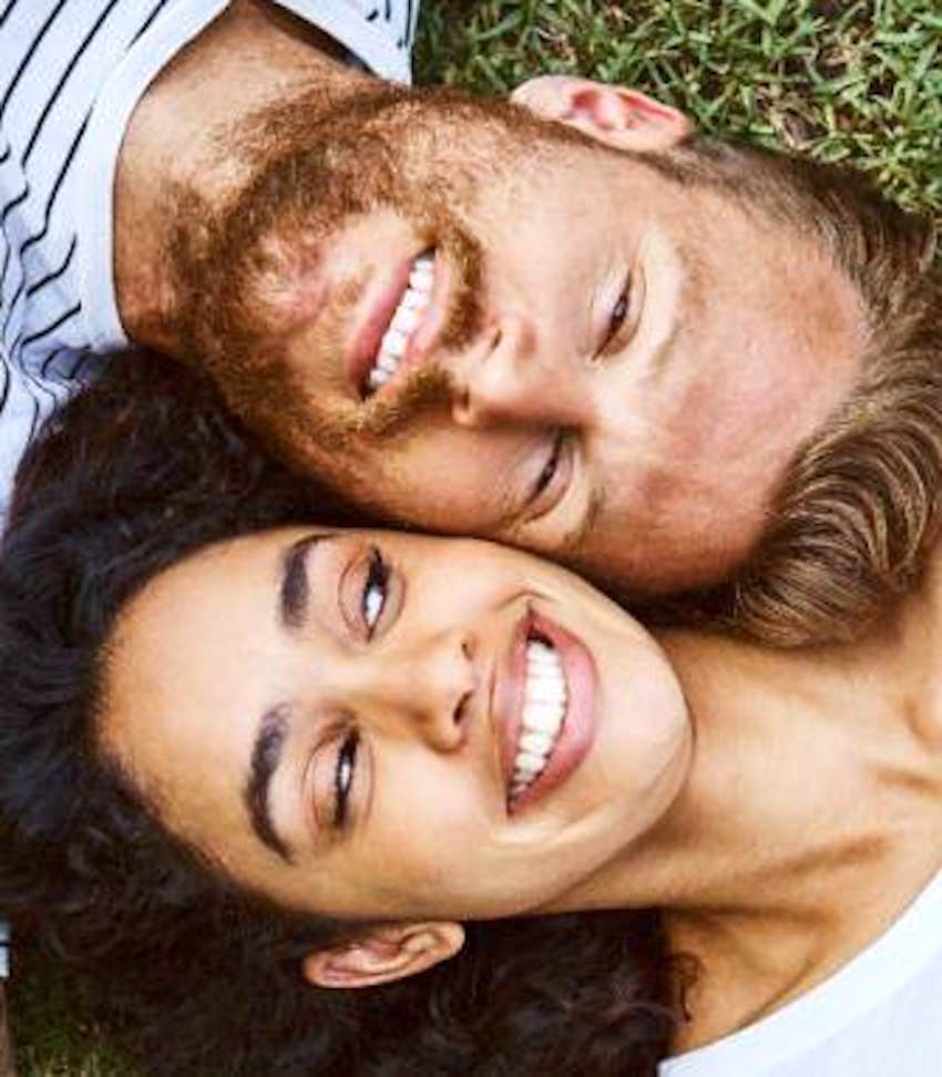 happy couple relaxing on the grass